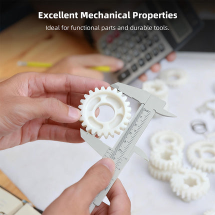 White 3D-printed gear held with calipers for measuring on a work surface